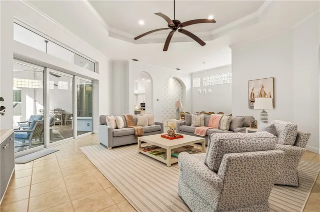 a living room with furniture and a chandelier