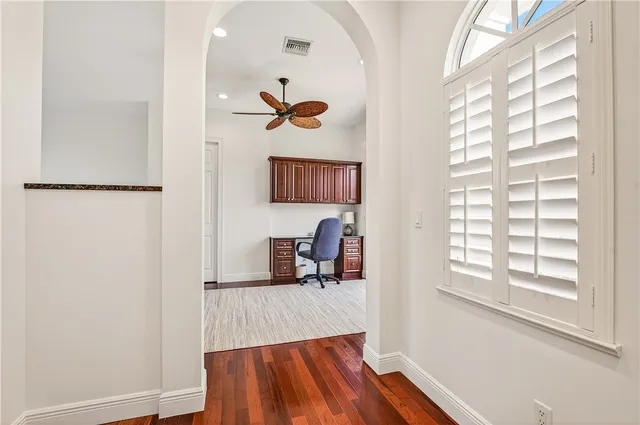 a view of a hallway with a window and couch