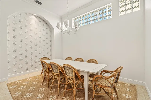 a view of a dining room with furniture and chandelier