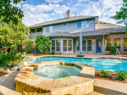 a view of a house with swimming pool and a yard