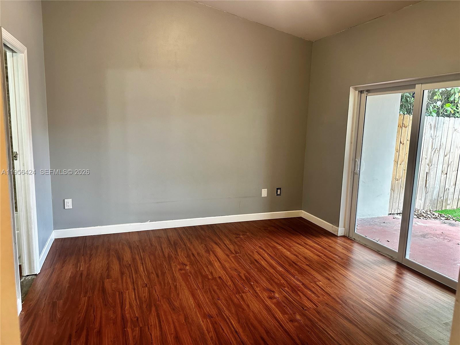4249 Southwest 154th Avenue Miami, FL 33185 - Photo 14 of 24 a view of an empty room with wooden floor and a window