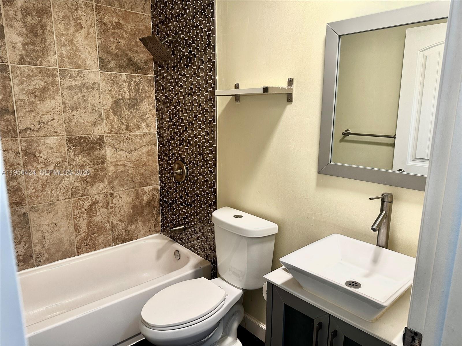 4249 Southwest 154th Avenue Miami, FL 33185 - Photo 16 of 24 a white toilet sitting next to a bathroom sink