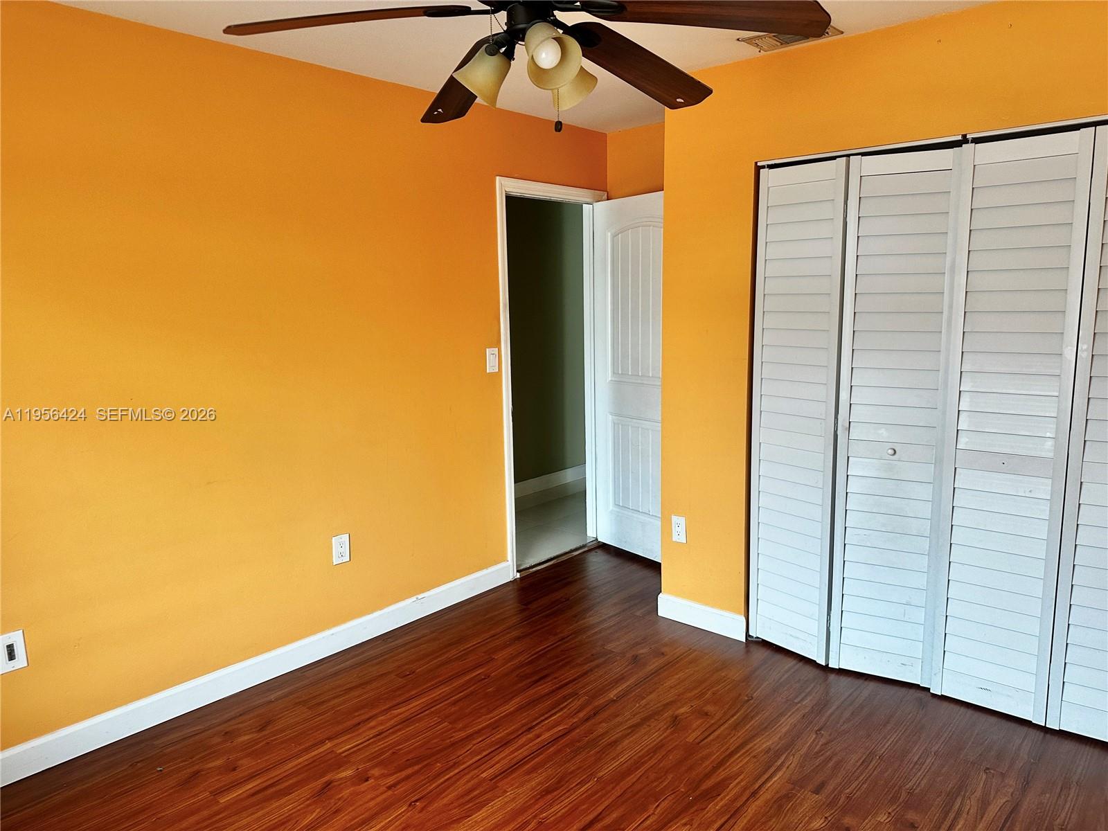 4249 Southwest 154th Avenue Miami, FL 33185 - Photo 20 of 24 an empty room with wooden floor and closet