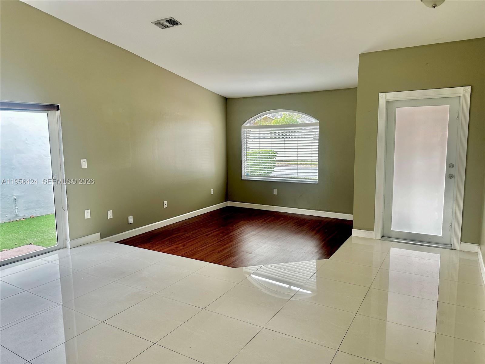 4249 Southwest 154th Avenue Miami, FL 33185 - Photo 4 of 24 an empty room with a empty space and windows