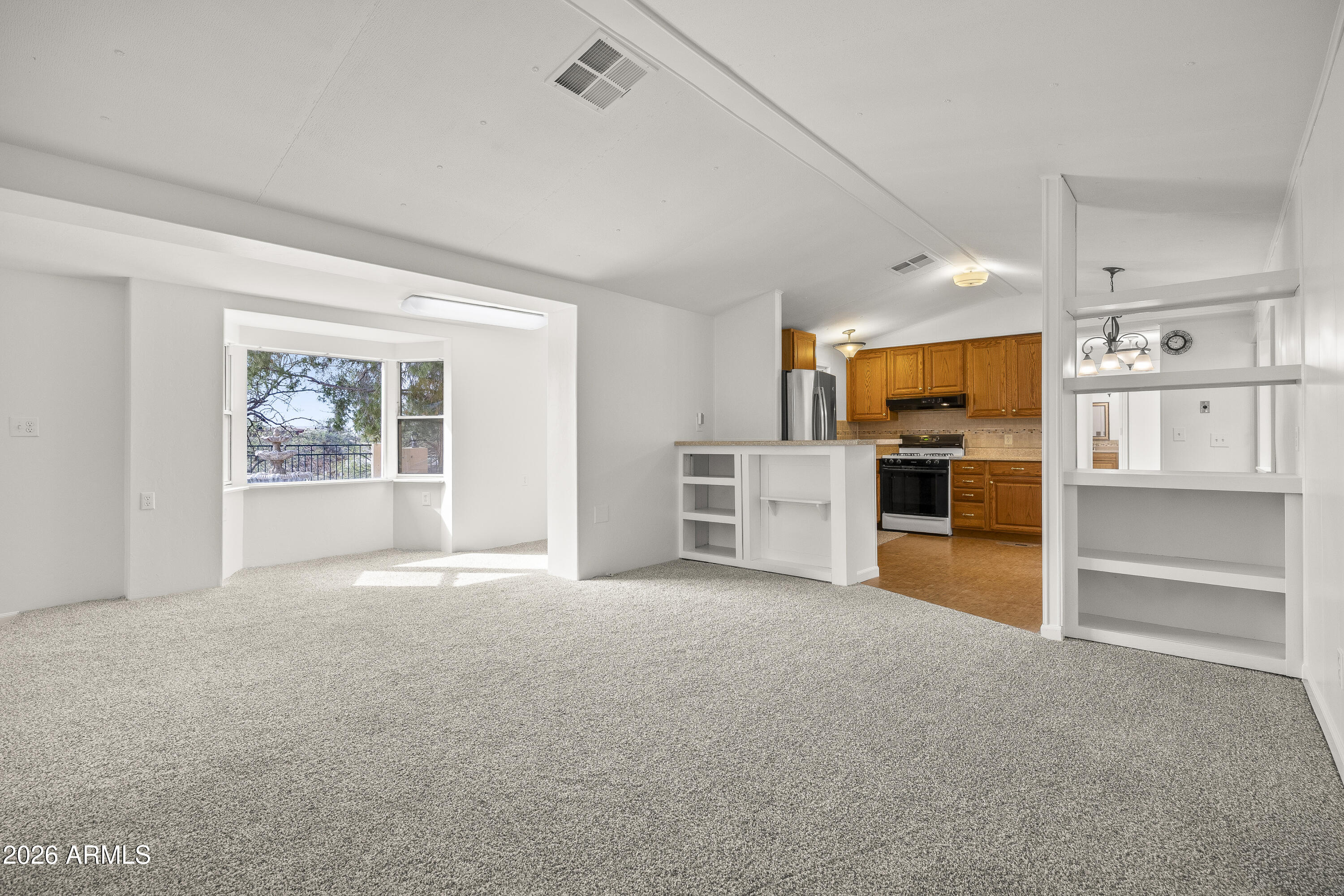 15940 North Goetz Place Tucson, AZ 85739 - Photo 1 of 37 a view of a kitchen with a sink cabinets and a living room