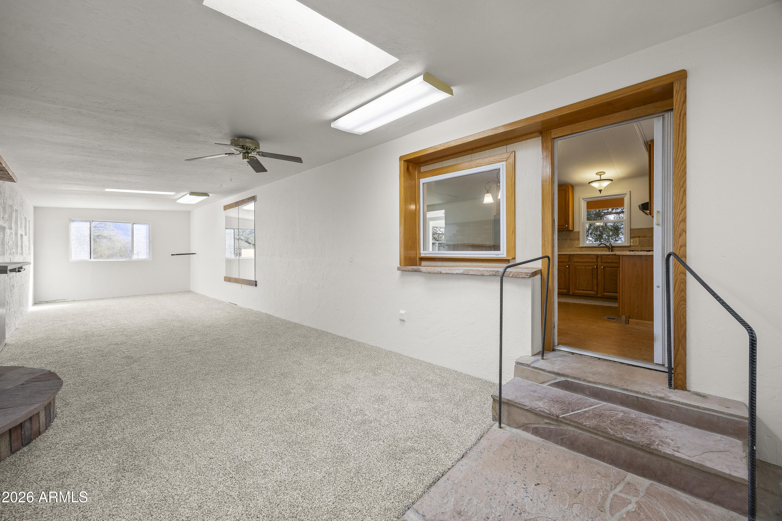 15940 North Goetz Place Tucson, AZ 85739 - Photo 11 of 37 a view of a hallway with wooden floor and a living room