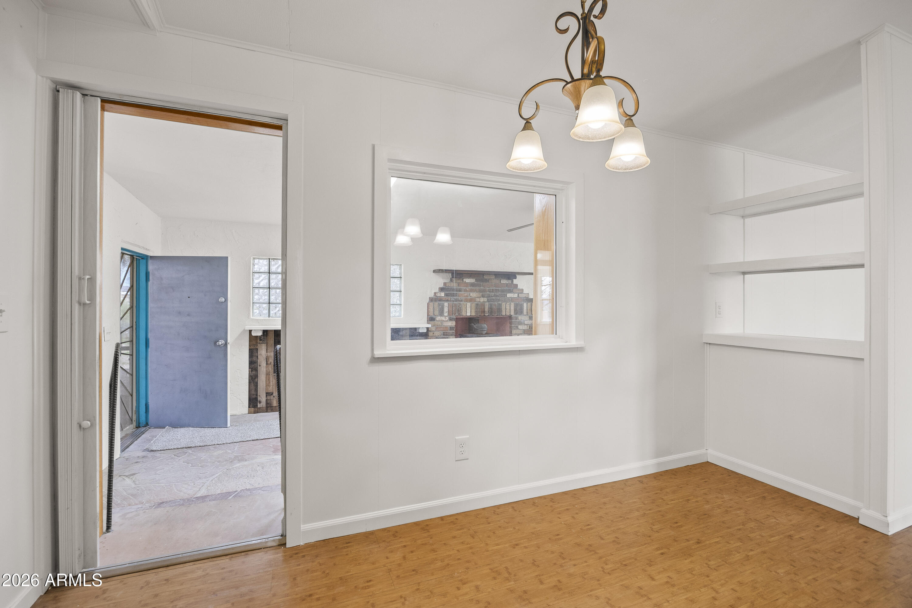 15940 North Goetz Place Tucson, AZ 85739 - Photo 12 of 37 an empty room with wooden floor and windows