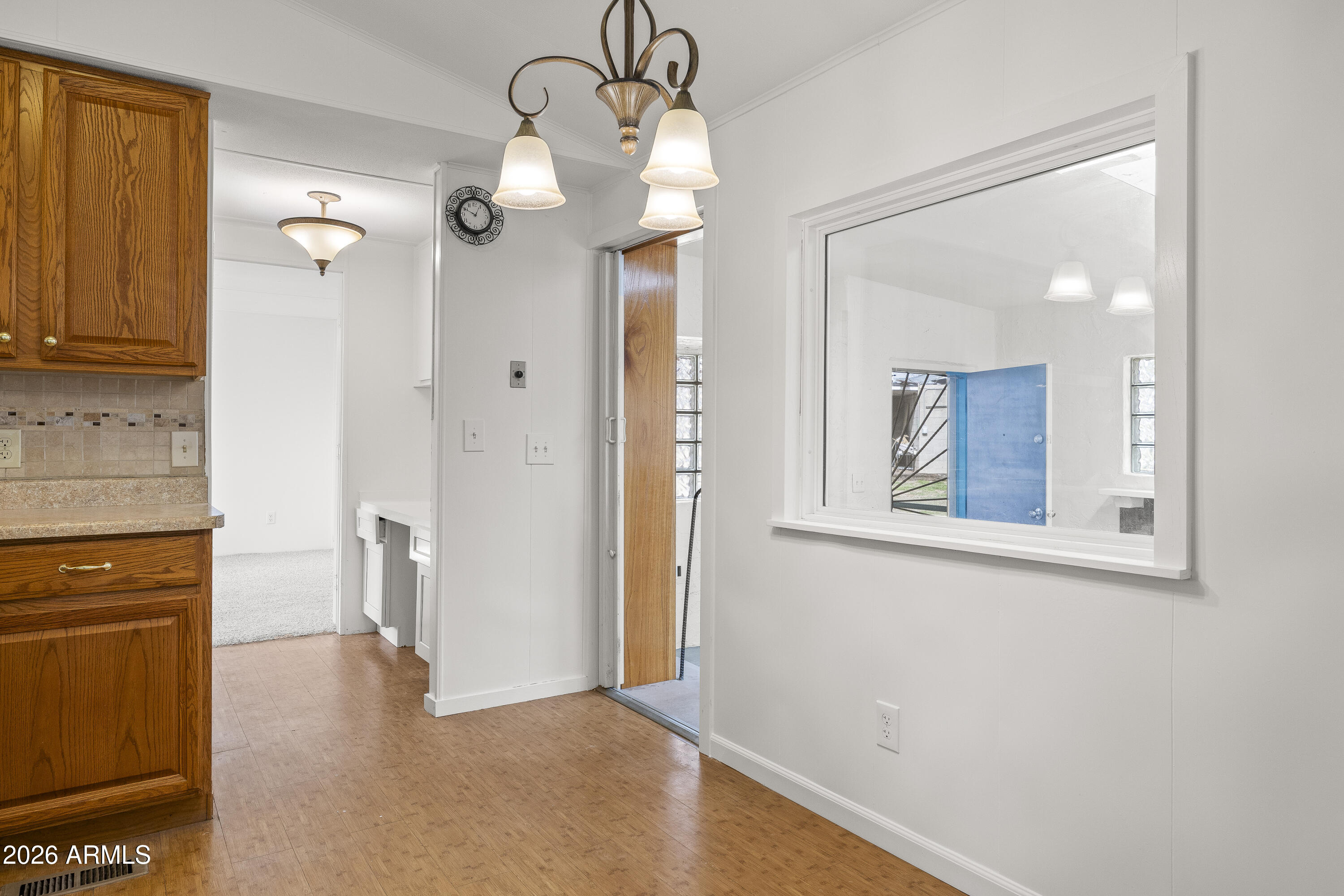 15940 North Goetz Place Tucson, AZ 85739 - Photo 13 of 37 a view of a hallway with wooden floor and a cabinet