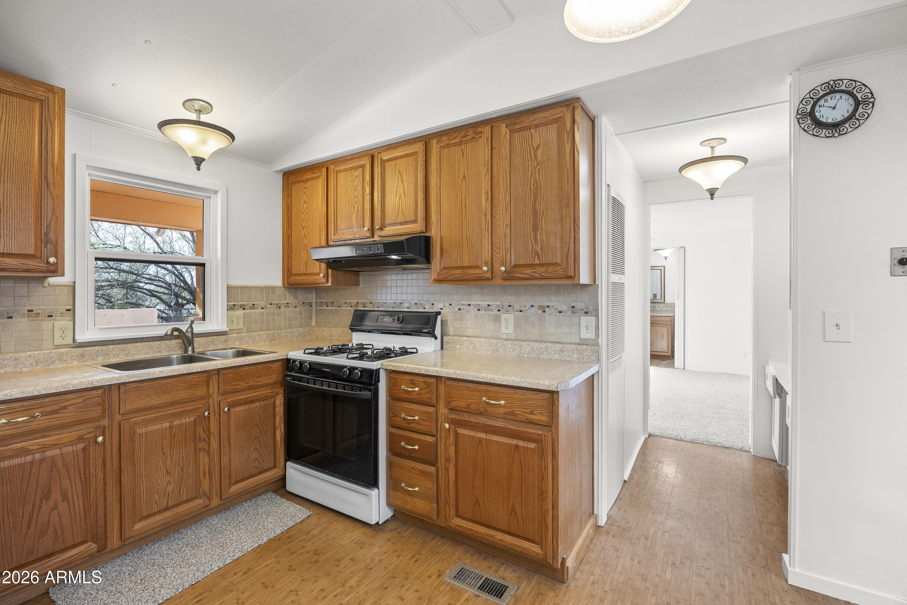 15940 North Goetz Place Tucson, AZ 85739 - Photo 14 of 37 a kitchen with stainless steel appliances granite countertop a stove sink and cabinets