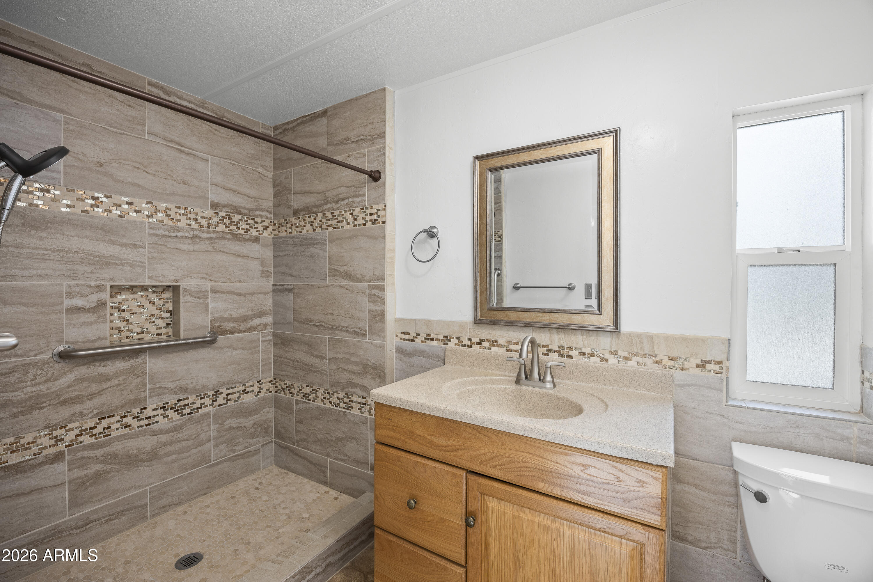 15940 North Goetz Place Tucson, AZ 85739 - Photo 27 of 37 a bathroom with a sink shower and a mirror
