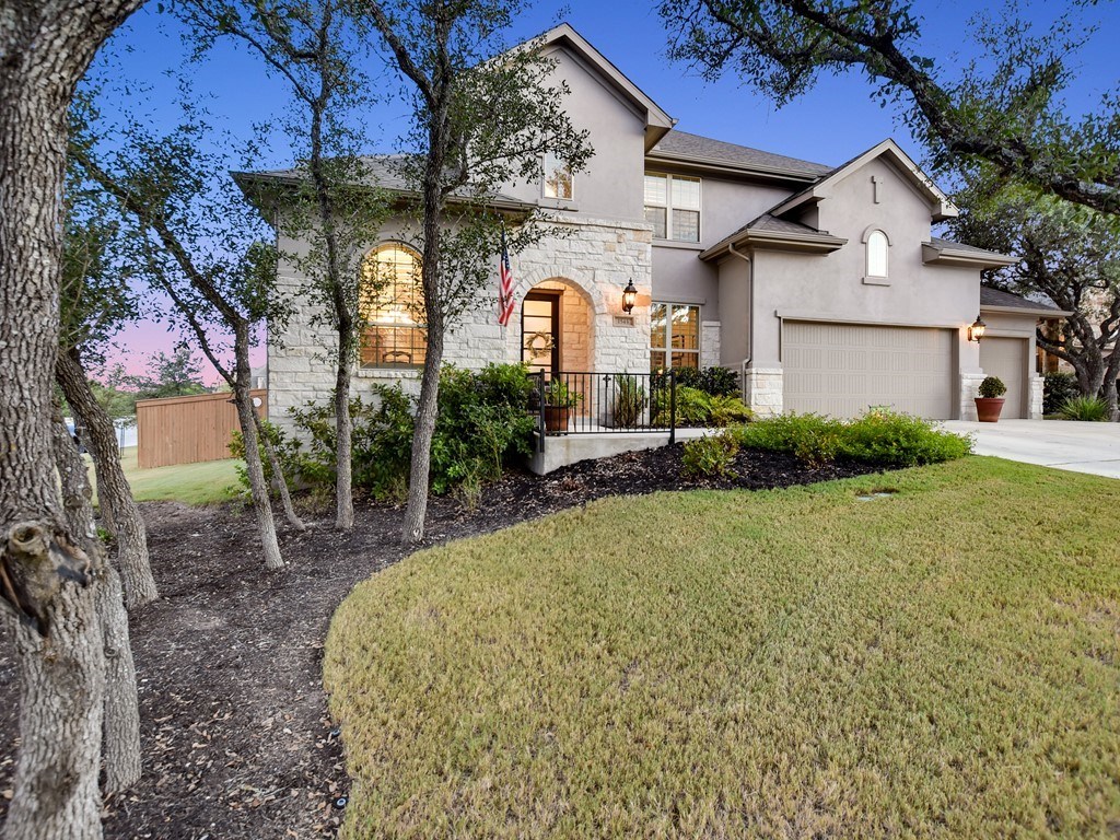 a front view of a house with garden