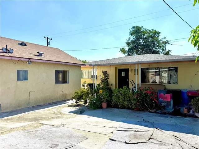 a view of a house with sitting area and potted plants