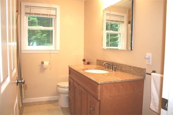 42 Indian Spring Road Ashland, MA 01721 - Photo 9 of 17 a bathroom with a granite countertop sink a toilet and a window