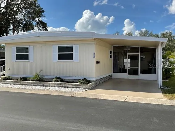 a view of a house with a yard and garage