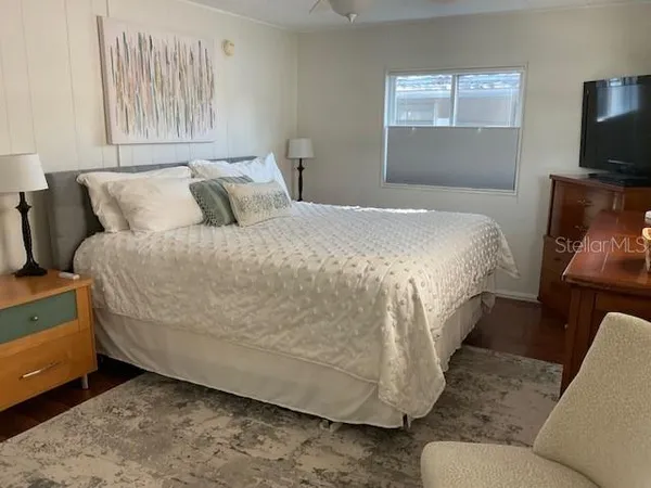 a bed sitting in a bedroom next to a window