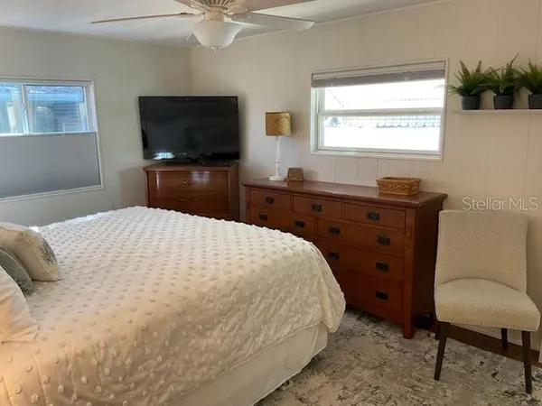 a bedroom with a bed and a flat screen tv