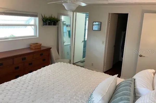 a bedroom with a bed and a window