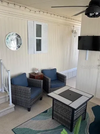 a living room with furniture a rug and a window