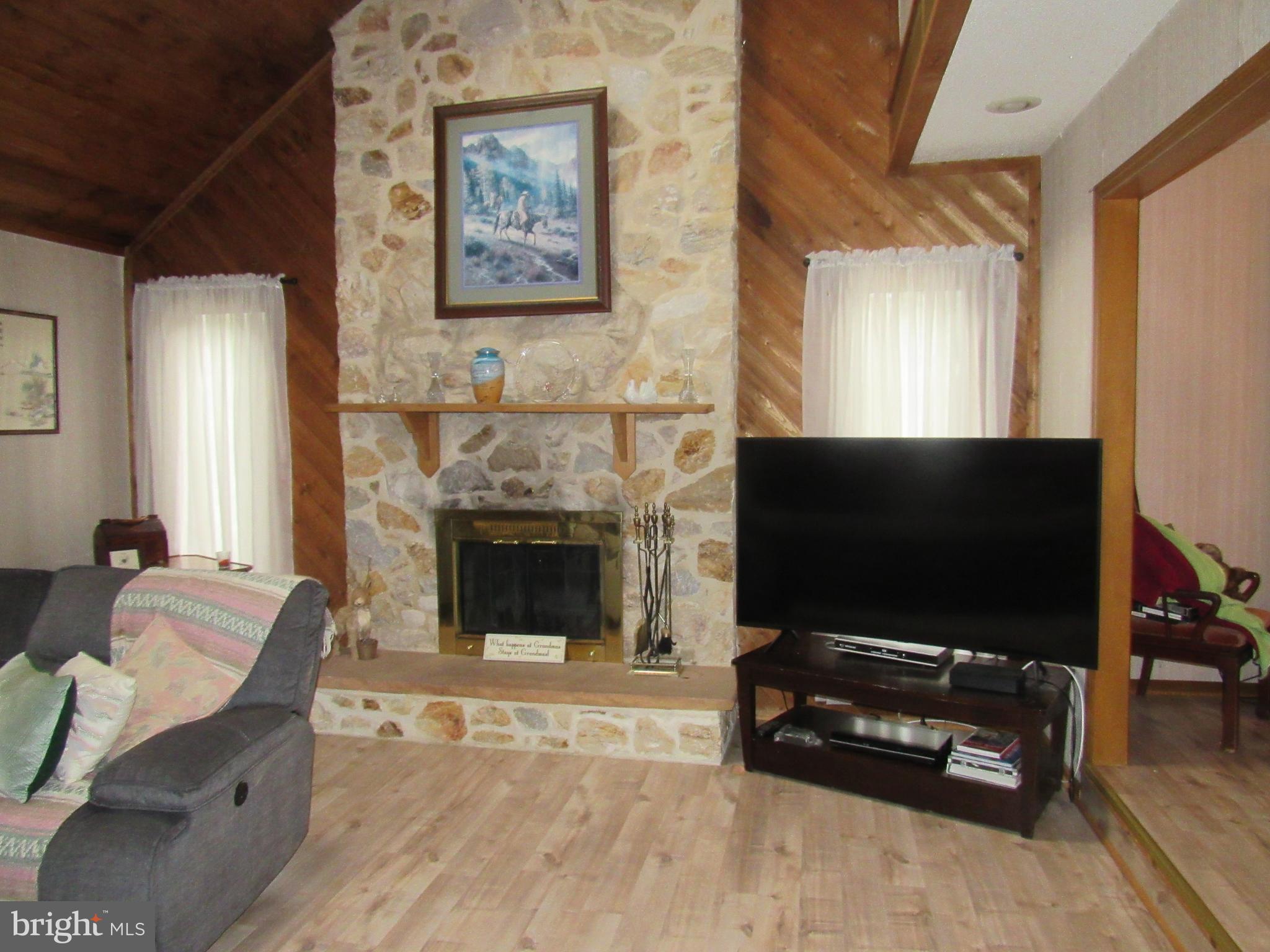 15 Cedar Grove Road Mullica Hill, NJ 08062 - Photo 13 of 41 a living room with furniture a flat screen tv and a fireplace