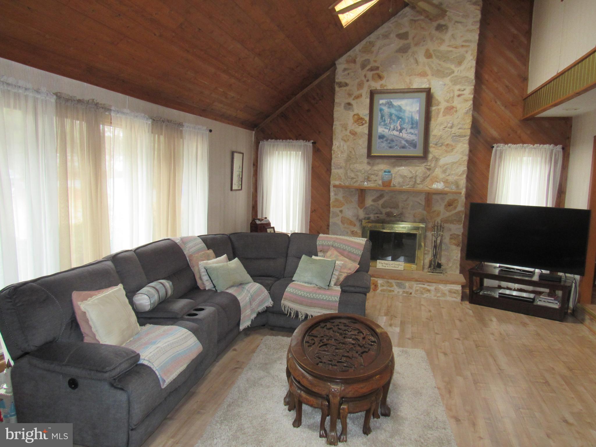 15 Cedar Grove Road Mullica Hill, NJ 08062 - Photo 14 of 41 a living room with furniture a flat screen tv and a fireplace