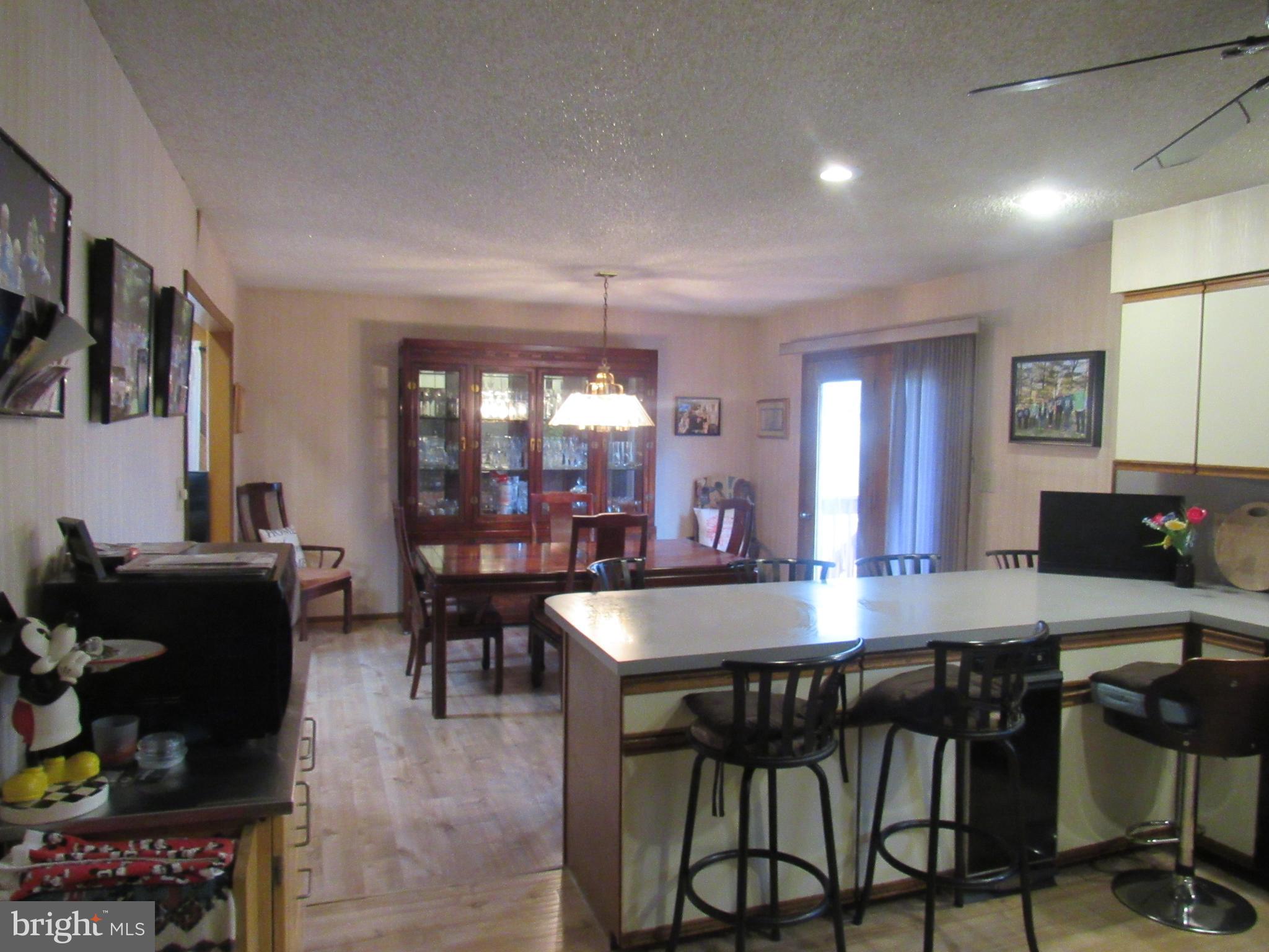 15 Cedar Grove Road Mullica Hill, NJ 08062 - Photo 22 of 41 a room with stainless steel appliances kitchen island granite countertop a dining table chairs and a refrigerator