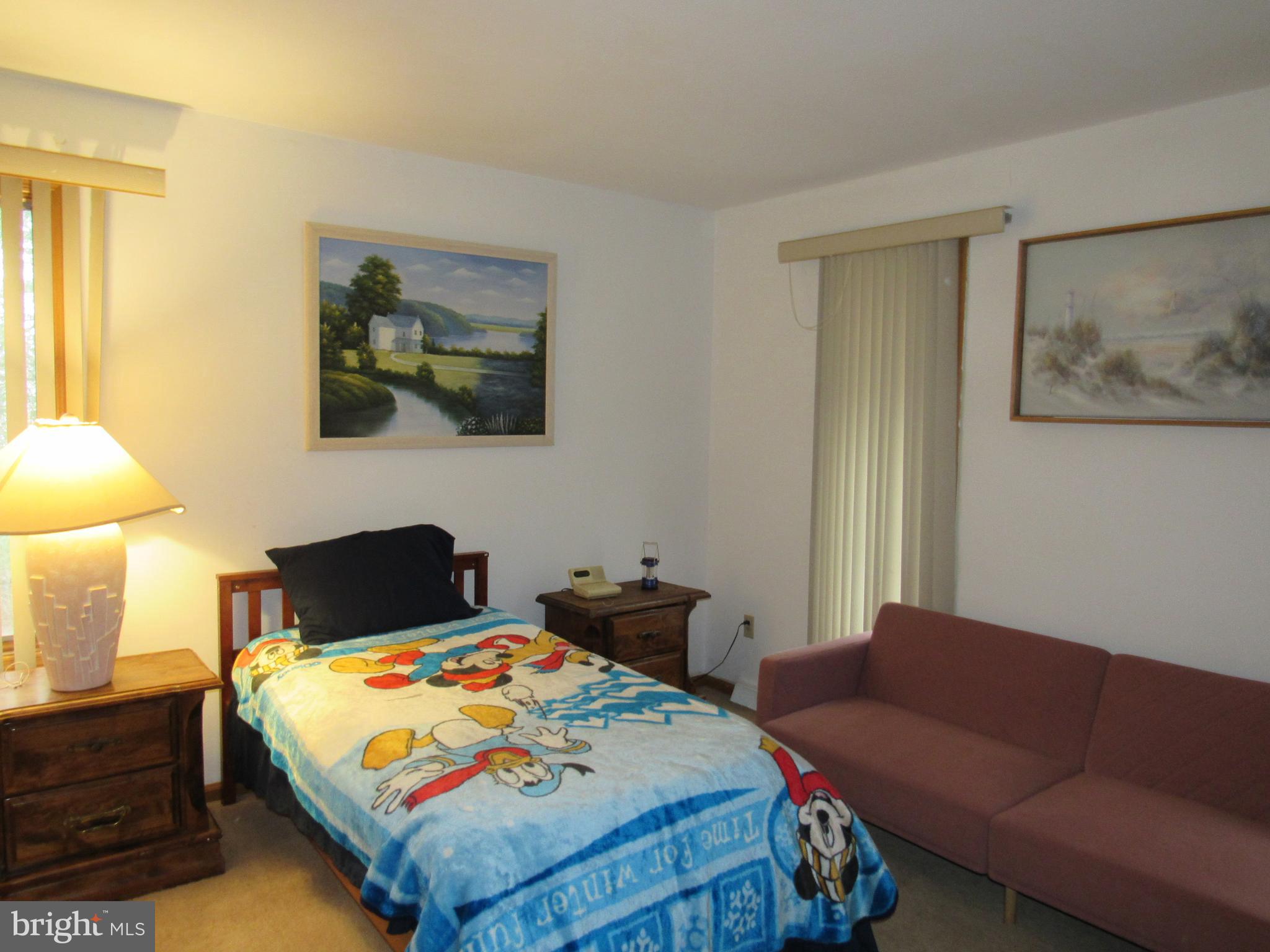 15 Cedar Grove Road Mullica Hill, NJ 08062 - Photo 28 of 41 a bedroom with a bed a couch and a lamp on the dresser