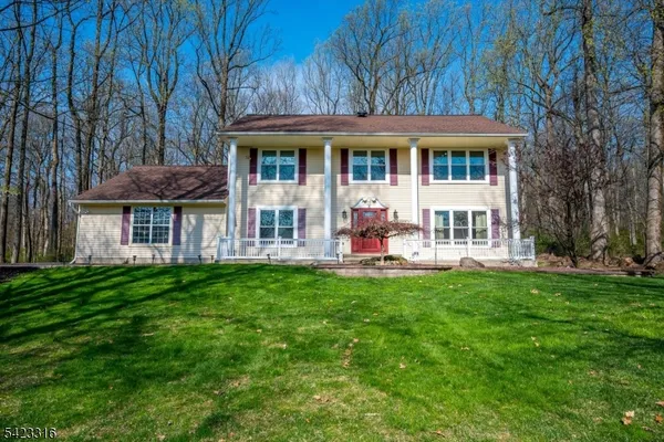 a view of a house with a backyard