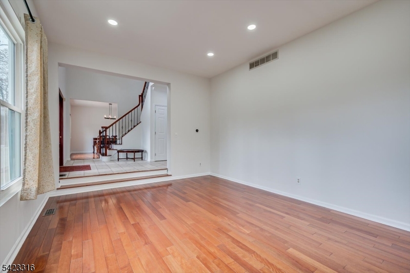 9 Stirrup Way Princeton, NJ 08540 - Photo 13 of 50 a view of a hallway with wooden floor and a fireplace