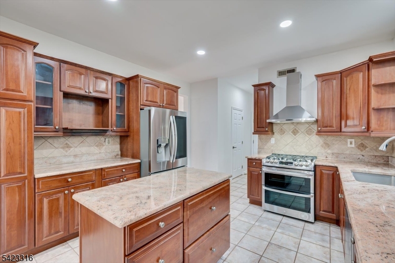 9 Stirrup Way Princeton, NJ 08540 - Photo 17 of 50 a kitchen with stainless steel appliances granite countertop a stove a sink and a refrigerator