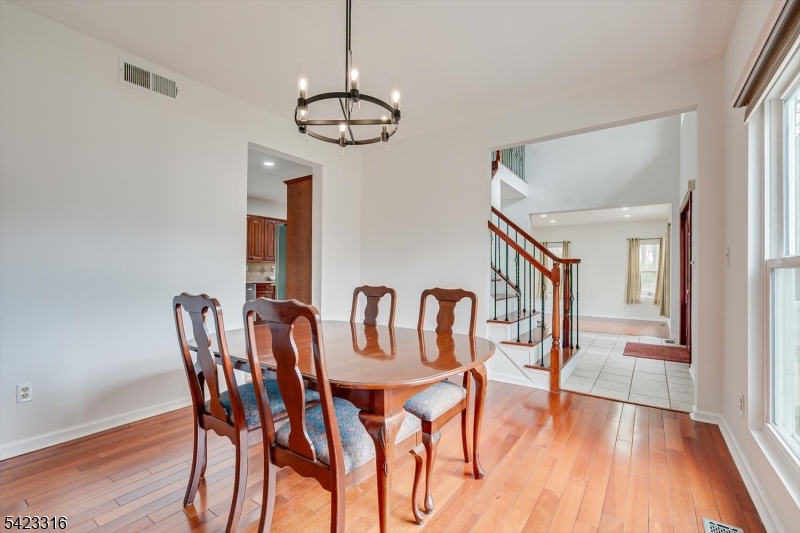 9 Stirrup Way Princeton, NJ 08540 - Photo 21 of 50 a view of a dining room with furniture wooden floor and chandelier