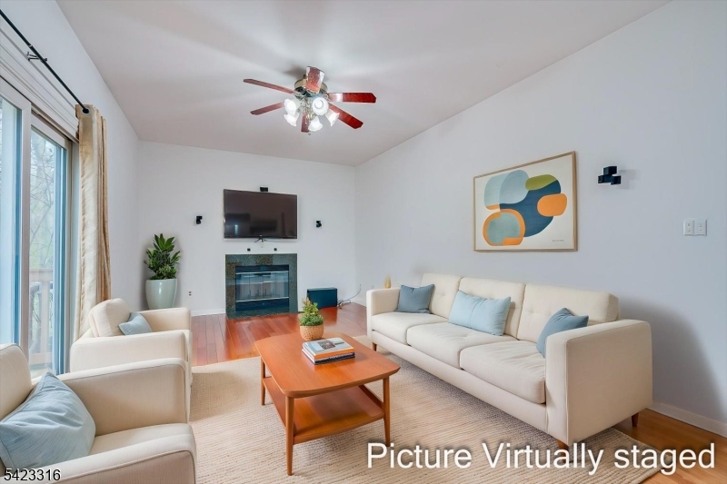 9 Stirrup Way Princeton, NJ 08540 - Photo 23 of 50 a living room with furniture a fireplace and a flat screen tv