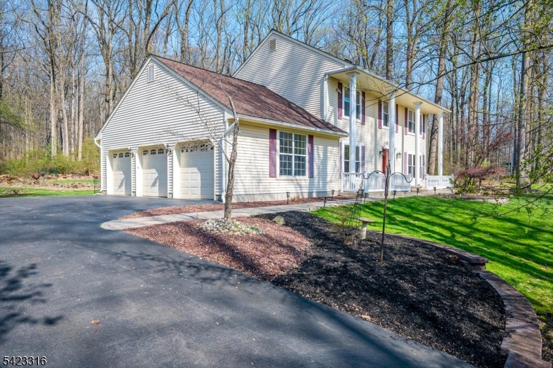 9 Stirrup Way Princeton, NJ 08540 - Photo 3 of 50 a front view of a house with a garden and trees