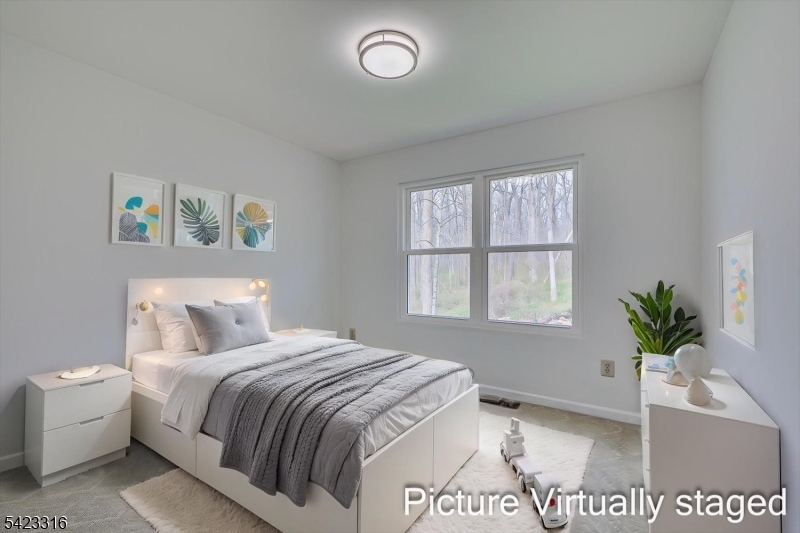 9 Stirrup Way Princeton, NJ 08540 - Photo 34 of 50 a bedroom with a bed and a potted plant