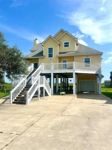 a view of house with yard and entertaining space