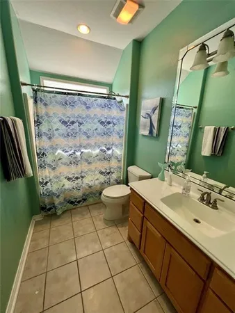 a bathroom with a sink mirror toilet and shower
