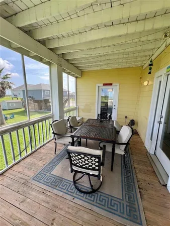 a living room with a couch a table and wooden floor