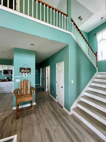 a living room with furniture and stairs