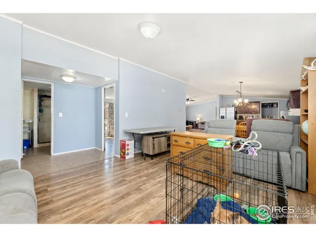 a living room with furniture and kitchen view