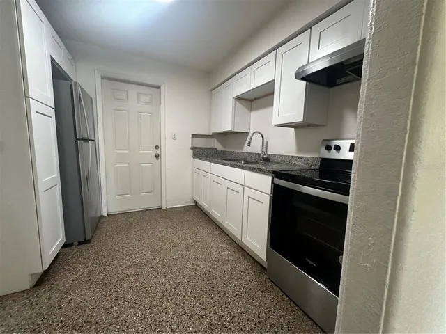 a kitchen with stainless steel appliances a stove and a refrigerator