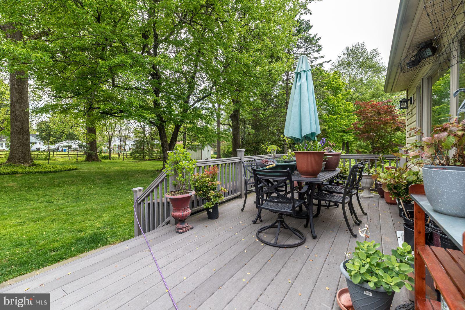534 Pinney Road Huntingdon Valley, PA 19006 - Photo 23 of 26 a view of a patio with table and chairs potted plants and a large tree
