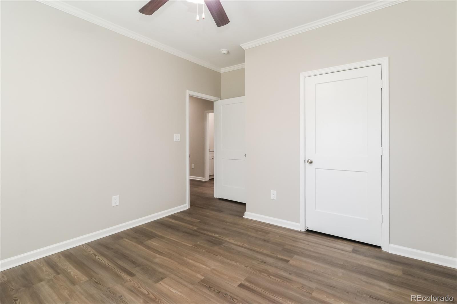 4385 Malta Street Denver, CO 80249 - Photo 12 of 16 an empty room with wooden floor and closet