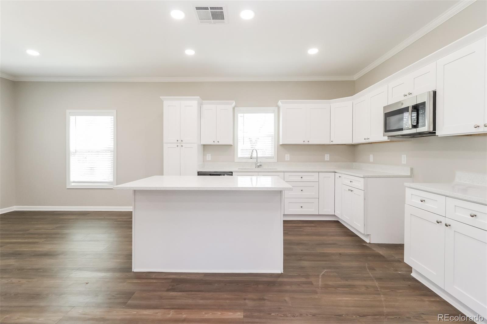 4385 Malta Street Denver, CO 80249 - Photo 7 of 16 a kitchen with a white wooden cabinets and window