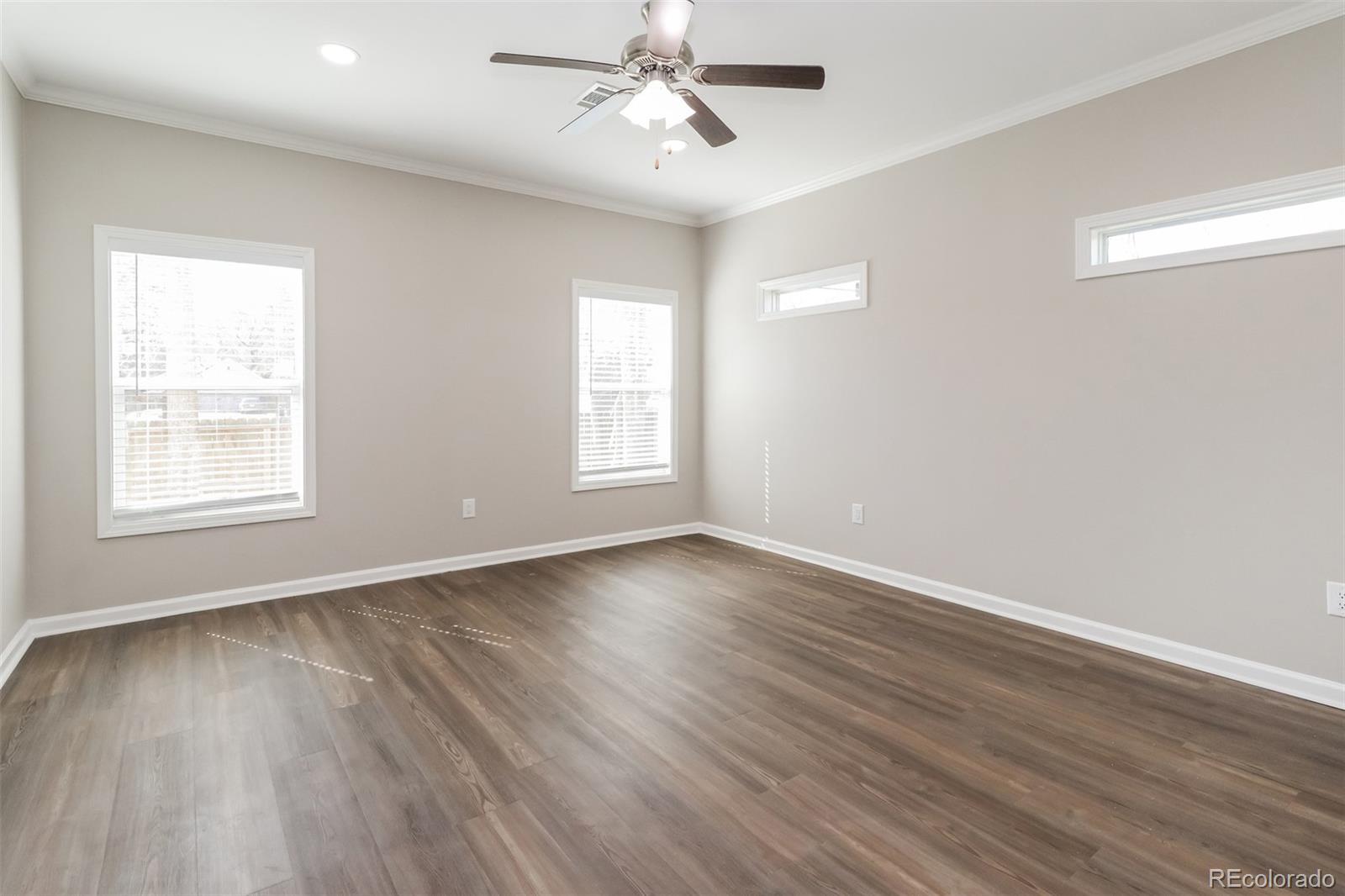 4385 Malta Street Denver, CO 80249 - Photo 8 of 16 wooden floor in an empty room with a window