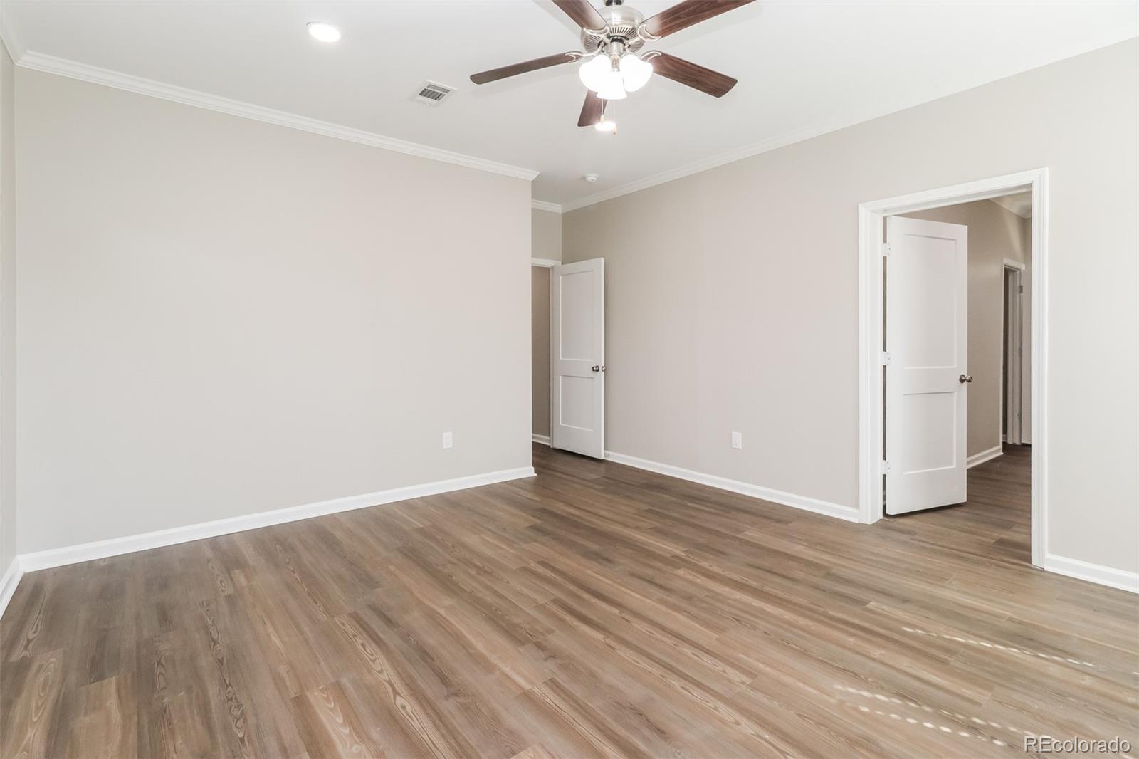 4385 Malta Street Denver, CO 80249 - Photo 9 of 16 a view of an empty room with wooden floor