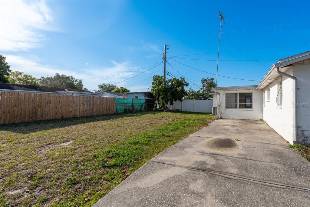3706 Cambridge Street New Port Richey, FL 34652 - Photo 26 of 29 BACK DRIVEWAY / YARD