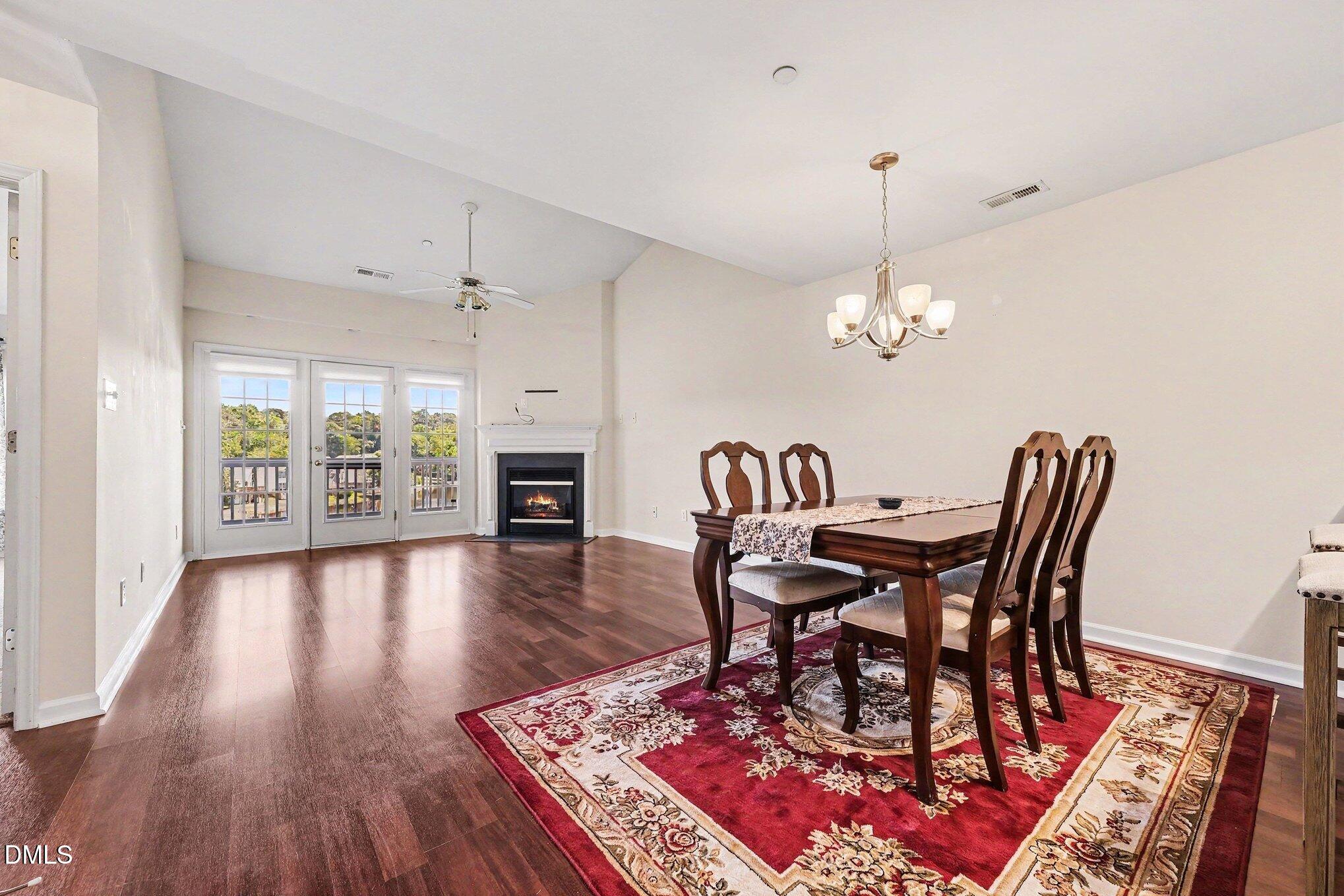 132 Springfork Drive Cary, NC 27513 - Photo 13 of 28 a view of a dining room with furniture wooden floor and chandelier