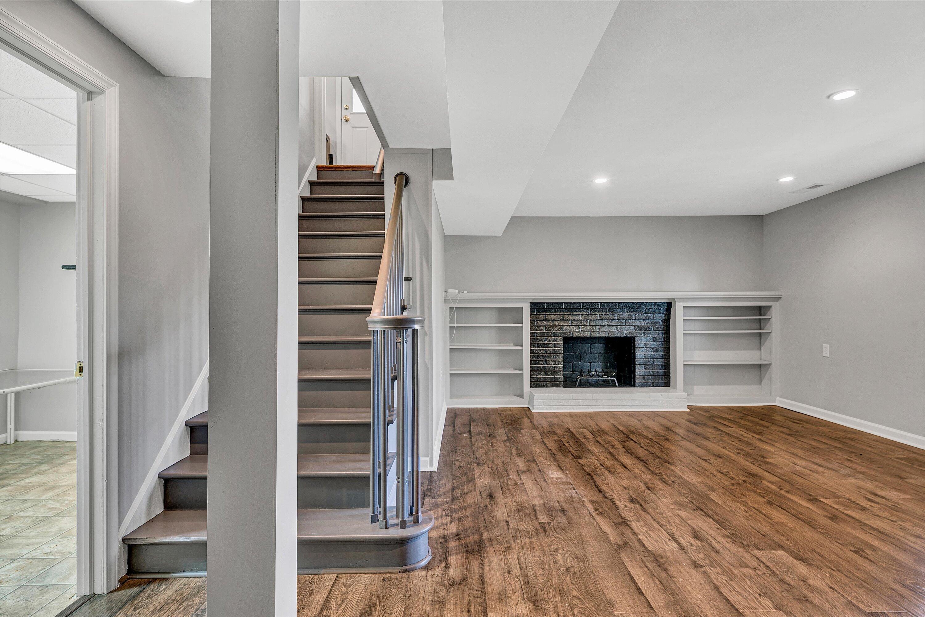 3259 Rasmont Road Roanoke, VA 24018 - Photo 22 of 36 a view of kitchen and hallway with wooden floor and a fireplace