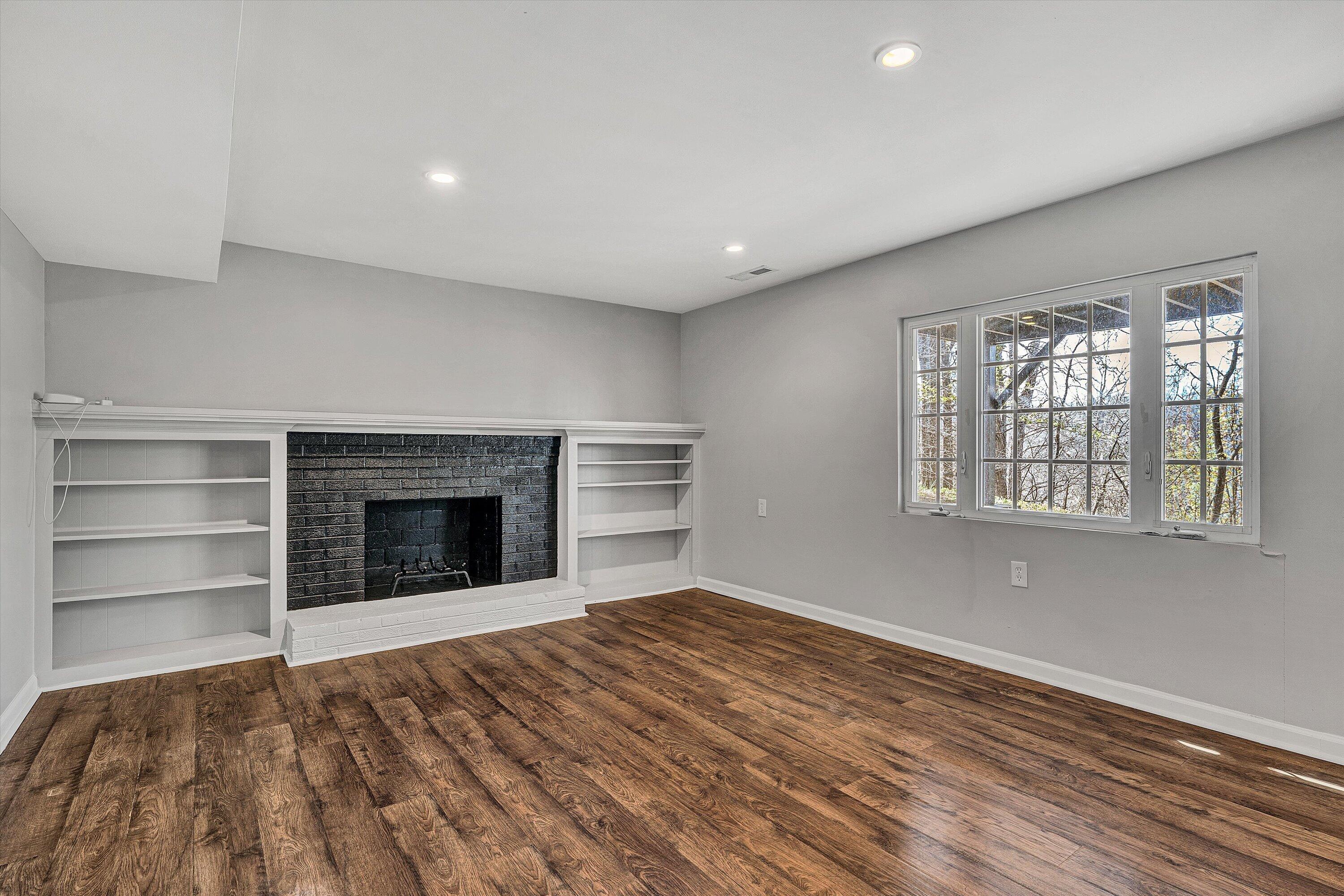 3259 Rasmont Road Roanoke, VA 24018 - Photo 23 of 36 a view of an empty room with a fireplace and a window