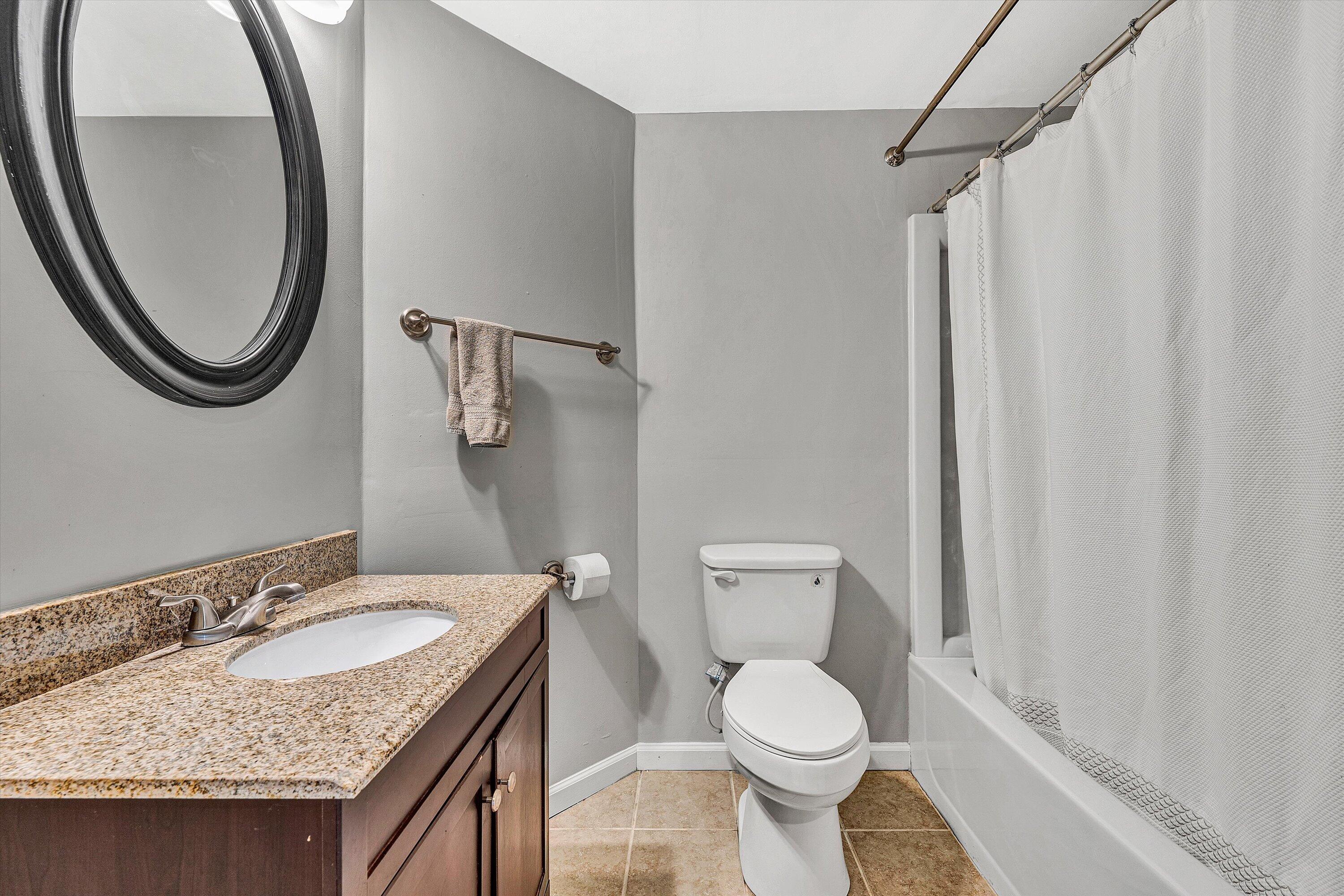 3259 Rasmont Road Roanoke, VA 24018 - Photo 26 of 36 a bathroom with a granite countertop sink toilet and a mirror