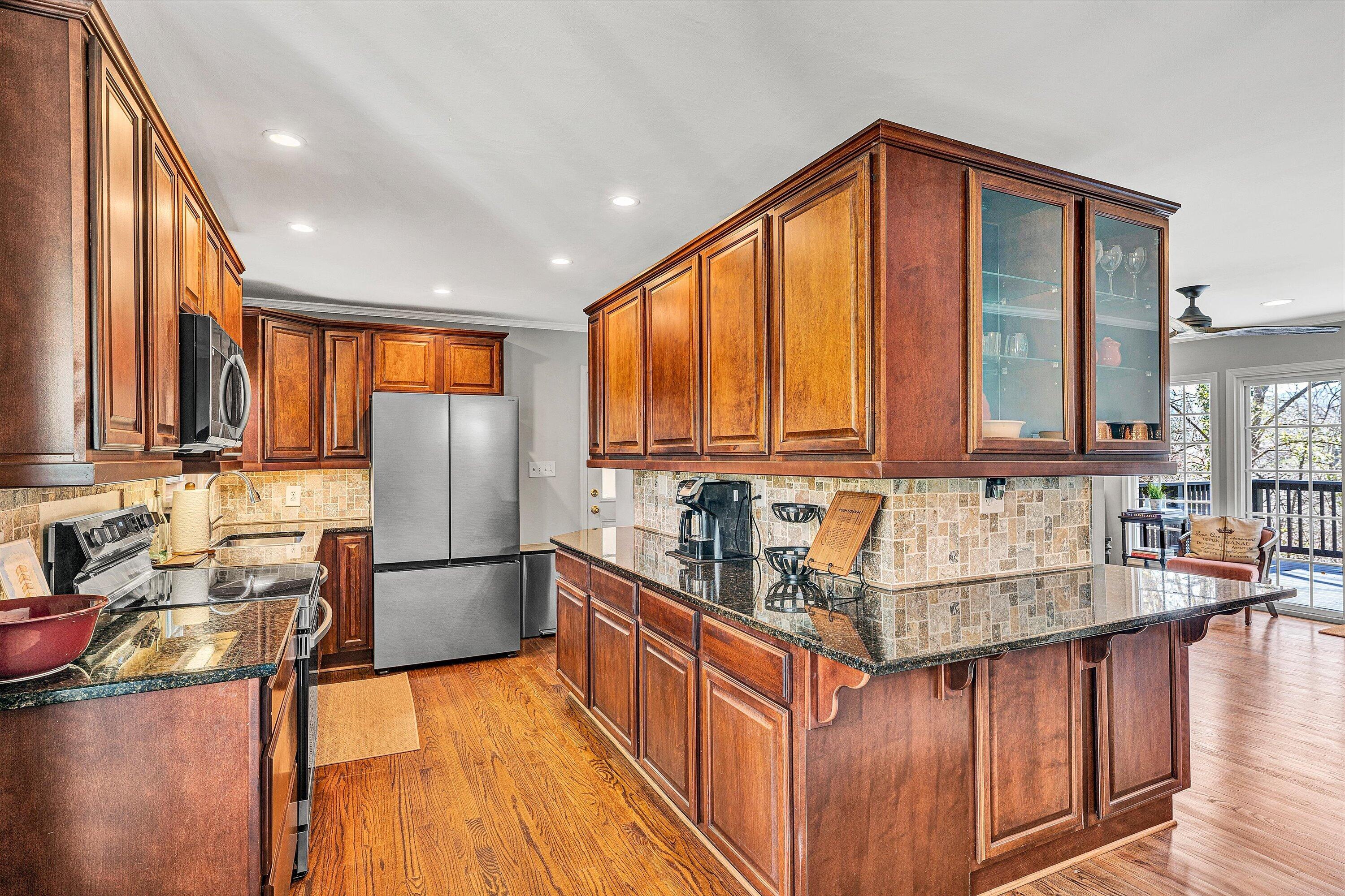 3259 Rasmont Road Roanoke, VA 24018 - Photo 7 of 36 a kitchen with stainless steel appliances granite countertop a sink stove and refrigerator
